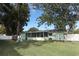 Large backyard with grassy area, mature trees, and playset at 30 Old Barn Way, Casselberry, FL 32707