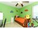 bedroom with green walls and dinosaur decor at 30 Old Barn Way, Casselberry, FL 32707