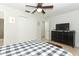 Bright bedroom with a checkered bedspread and built-in closet at 30 Old Barn Way, Casselberry, FL 32707