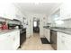 Modern kitchen featuring white cabinets and stainless steel appliances at 30 Old Barn Way, Casselberry, FL 32707