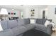 Spacious living room with gray sectional sofa and coffee table at 30 Old Barn Way, Casselberry, FL 32707