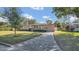 Tan house with a paved driveway and landscaped lawn at 3020 Nancy St, Orlando, FL 32806