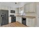 Modern kitchen featuring granite counters and black appliances at 3020 Nancy St, Orlando, FL 32806