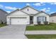 Curb appeal! This one-story home features a two-car garage and well-manicured lawn at 3101 Royal Tern Dr, Winter Haven, FL 33881