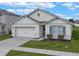 One-story house with two-car garage, landscaping, and neutral color scheme at 3101 Royal Tern Dr, Winter Haven, FL 33881