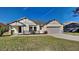 One-story home with a two-car garage and landscaped lawn at 3342 Saint Vincent Ln, Clermont, FL 34711