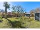 Large backyard with grassy area and playset at 402 Oak Lynn Dr, Orlando, FL 32809