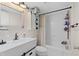 Clean bathroom with a tub, shelving, and updated vanity at 402 Oak Lynn Dr, Orlando, FL 32809