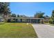 Newly painted ranch home with carport and spacious lawn at 402 Oak Lynn Dr, Orlando, FL 32809