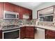 Kitchen corner with double sink and wood cabinets at 402 Oak Lynn Dr, Orlando, FL 32809