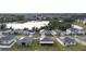 Wide aerial view of neighborhood with lake in background at 4530 Tahoe Cir, Clermont, FL 34714