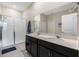 Modern bathroom with double vanity, large mirror, and walk-in shower at 4530 Tahoe Cir, Clermont, FL 34714