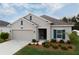 One-story home with beige exterior, blue shutters, and landscaped yard at 4530 Tahoe Cir, Clermont, FL 34714