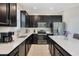 Modern kitchen with dark cabinetry, stainless steel appliances, and large island at 4530 Tahoe Cir, Clermont, FL 34714