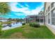 Landscaped backyard with pool, patio and lake views at 4832 Shoreline Cir, Sanford, FL 32771