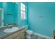 Small bathroom with light teal walls and white vanity at 4832 Shoreline Cir, Sanford, FL 32771