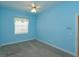 Light blue bedroom with carpet, window, and ceiling fan at 4832 Shoreline Cir, Sanford, FL 32771