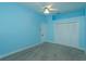 Light blue bedroom with carpet, ceiling fan, and double door closet at 4832 Shoreline Cir, Sanford, FL 32771