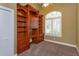 Home office with built-in wooden shelving and desk at 4832 Shoreline Cir, Sanford, FL 32771