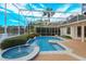 Resort-style screened pool and spa with lake view at 4832 Shoreline Cir, Sanford, FL 32771