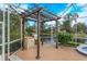 Outdoor kitchen area with pergola and lake view at 4832 Shoreline Cir, Sanford, FL 32771