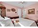 Bedroom with wooden bed and soft pink walls at 5408 Kalmia Dr, Orlando, FL 32807