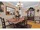 Formal dining room with antique table, chandelier, and display cabinet at 5408 Kalmia Dr, Orlando, FL 32807