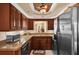 Well-equipped kitchen with dark wood cabinets and granite countertops at 5408 Kalmia Dr, Orlando, FL 32807