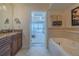 Bathroom with double vanity and a view of the bedroom at 5501 S Atlantic Ave # 4150, New Smyrna Beach, FL 32169