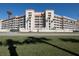 Sunbay condo building, featuring multiple stories, balconies, and palm trees at 5501 S Atlantic Ave # 4150, New Smyrna Beach, FL 32169