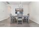 Dining room with gray table and chairs, and modern light fixture at 6145 Citrus Grove Ct, St Cloud, FL 34771