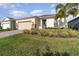 Tan house with two-car garage and landscaped yard at 6145 Citrus Grove Ct, St Cloud, FL 34771