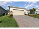 Two-car garage with paver driveway and landscaping at 6145 Citrus Grove Ct, St Cloud, FL 34771