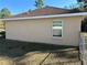 Side view of house with a single window and chain-link fence at 7047 Sw 131St Loop, Ocala, FL 34473