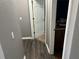 Gray hallway with wood-look flooring and a door at 7047 Sw 131St Loop, Ocala, FL 34473