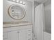 Clean bathroom with granite vanity and oval mirror at 715 Siena Palm Dr, Celebration, FL 34747