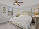 Bright bedroom with king-size bed, wood floors, and ceiling fan at 715 Siena Palm Dr, Celebration, FL 34747