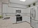 Modern kitchen with white cabinets, granite counters, and stainless appliances at 715 Siena Palm Dr, Celebration, FL 34747