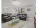 Living room with grey couches, coffee table, and wood-look floors at 715 Siena Palm Dr, Celebration, FL 34747