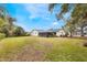 Large backyard with grassy lawn and mature trees at 7884 Broken Arrow Trl, Winter Park, FL 32792