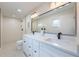 Bathroom featuring double vanity sinks, a large mirror, and modern black fixtures at 7884 Broken Arrow Trl, Winter Park, FL 32792