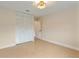 Bedroom with tile floors and louvered closet doors at 7884 Broken Arrow Trl, Winter Park, FL 32792