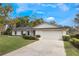 Charming single story home with a manicured lawn, beautiful trees, a 2-car garage, and freshly painted brick at 7884 Broken Arrow Trl, Winter Park, FL 32792