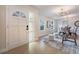 Inviting foyer leading to the dining and living areas with updated flooring and decorative lighting at 7884 Broken Arrow Trl, Winter Park, FL 32792