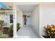 View of the front porch with a unique painted brick facade, decorative plants, and newly tiled patio at 7884 Broken Arrow Trl, Winter Park, FL 32792