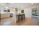 Modern kitchen with white cabinets, quartz countertops, and stainless steel appliances at 7884 Broken Arrow Trl, Winter Park, FL 32792