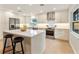 Modern kitchen with white shaker cabinets, stainless steel appliances, and a large island at 7884 Broken Arrow Trl, Winter Park, FL 32792