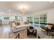 Bright living room features an open floor plan, connecting to the kitchen and backyard at 7884 Broken Arrow Trl, Winter Park, FL 32792