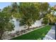 Landscaped backyard with artificial turf, white rock, and lush greenery at 830 W Canton Ave, Winter Park, FL 32789