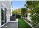 Artificial turf, white rock, and a deck create a modern, low-maintenance backyard at 830 W Canton Ave, Winter Park, FL 32789